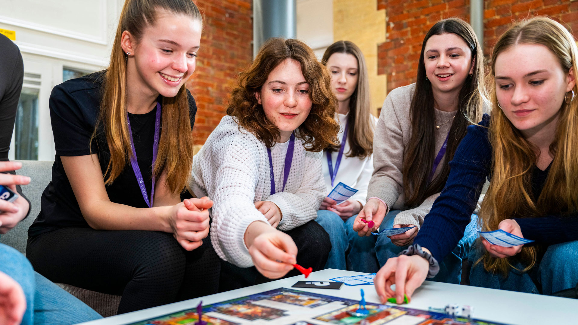 Sixth form students at Farnborough Hill in the common area playing games with friends.